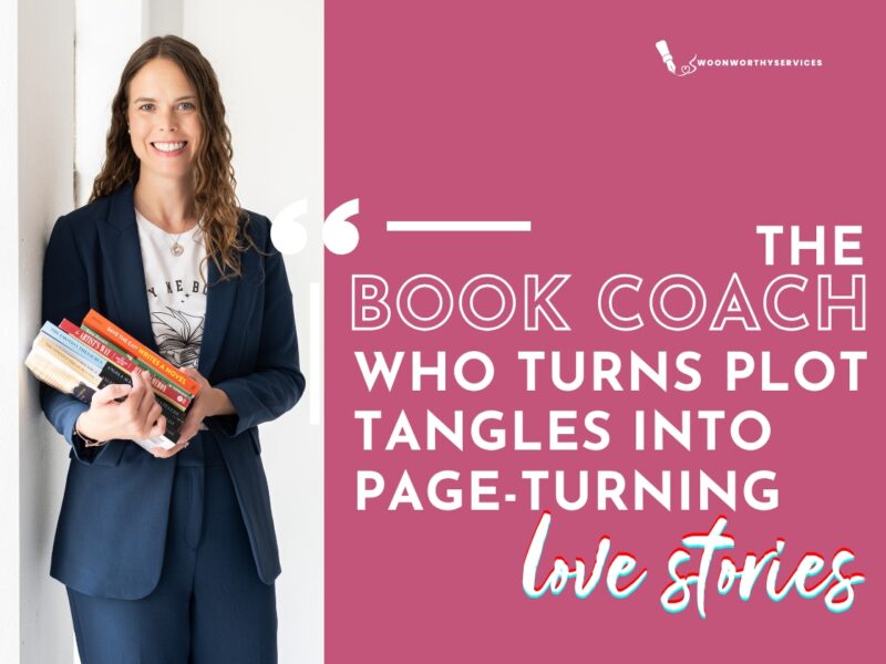 Photo of Jennifer Larkin wearing a blue suit and a white T-shirt, standing holding a stack of books