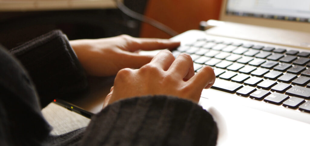 hands on a laptop keyboard